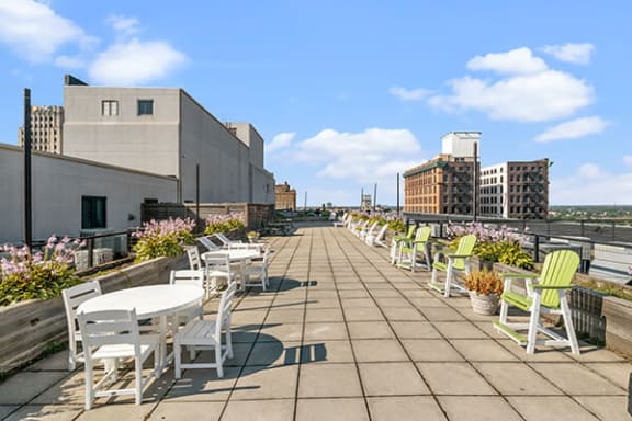 a terrace with tables and chairs on a roof
