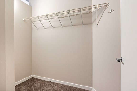 a closet with a hanging rack on the wall