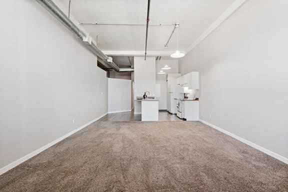 an empty room with a carpeted floor and white walls