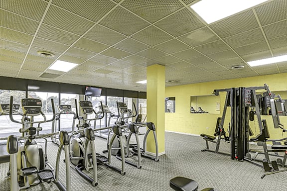 A gym with a variety of exercise equipment.