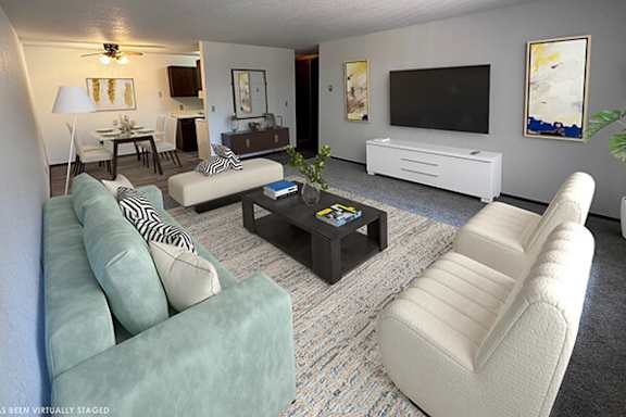 A living room with a white couch and a coffee table.