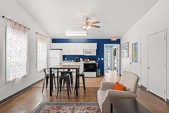 A dining room with a table and chairs.