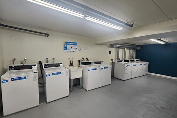 A laundromat with several washing machines.