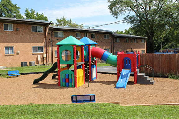 a playground with a slide and other toys in a yard