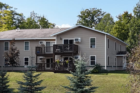 A large house with a balcony and a deck.