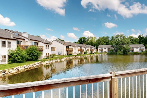 A row of houses are situated by a body of water.