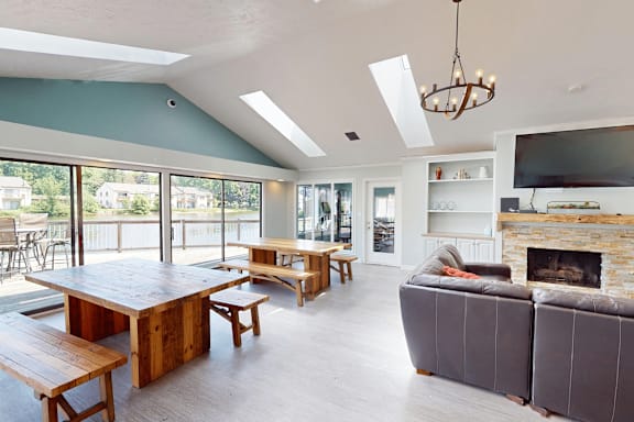 A modern living room with a fireplace and a large wooden table.