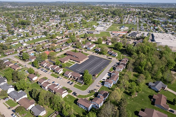 A residential area with houses and a parking lot.