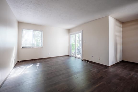 A room with wooden floors and a window.