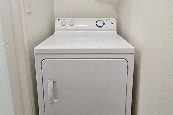 a white washer and dryer in a white room