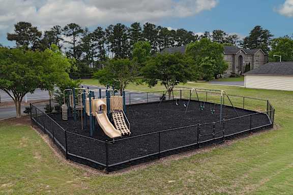 A playground with a slide and swings.