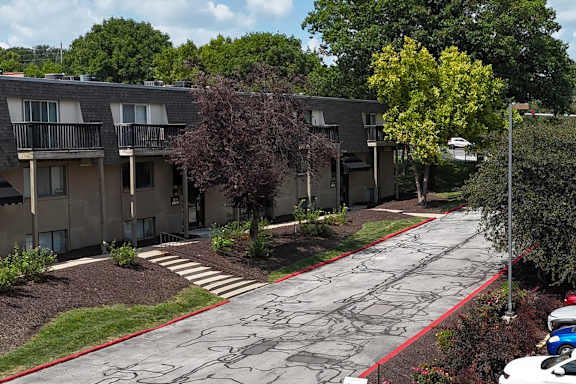 Apartment complex with a red line painted on the sidewalk.