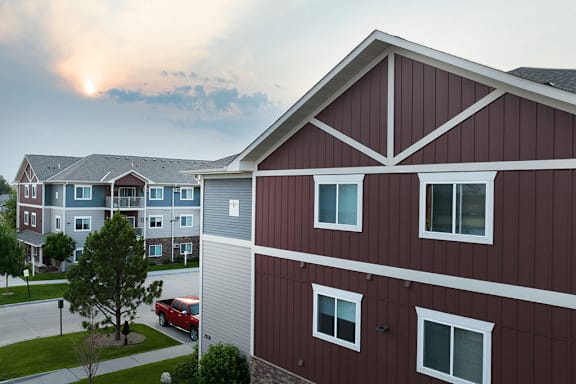 A red building with a white truck parked in front.