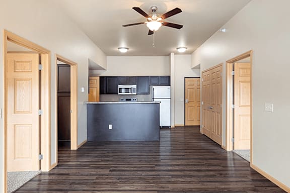 A kitchen with a refrigerator, microwave, and oven.