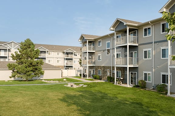 Apartment complex with a green lawn in front.