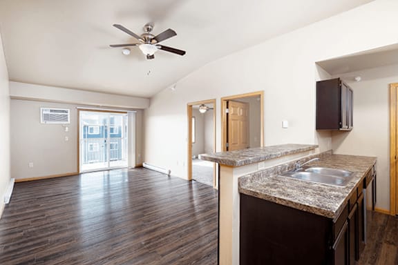 A kitchen with a counter top and a fan.