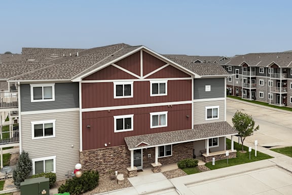 A large two story house with a red and grey exterior.