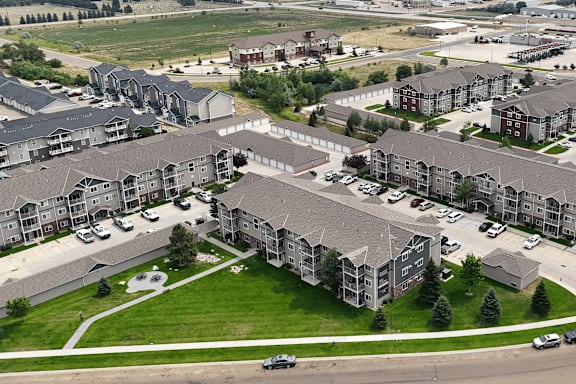 A large, well-maintained apartment complex with multiple buildings and green lawns.