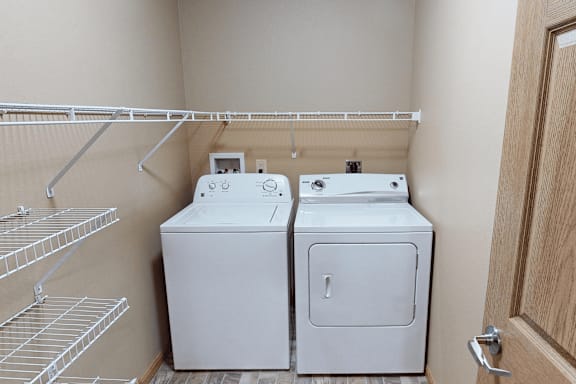 A small laundry room with a washer and dryer.