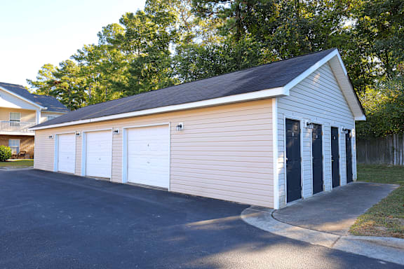 A two-car garage with a black door and white trim.