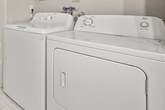 a white washer and dryer next to each other in a laundry room