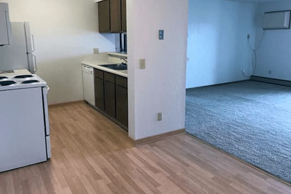 A kitchen with a white fridge and a white stove.
