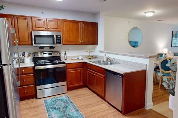A kitchen with wooden cabinets and a white countertop.