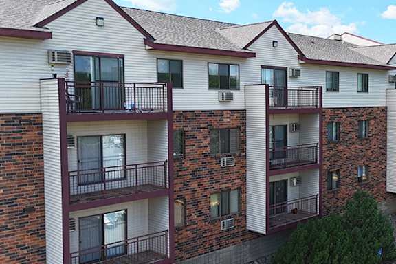 Apartment building with balconies and air conditioning units.