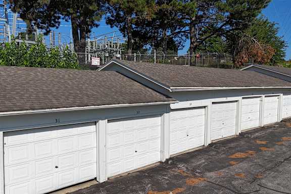 A row of white garage doors are closed.