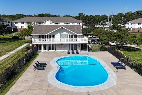 A large house with a pool in the backyard.