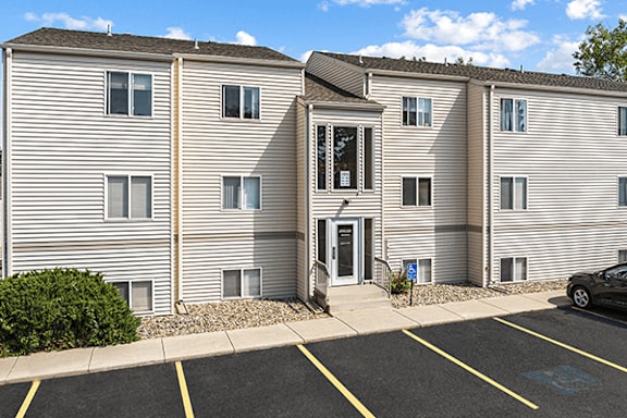 A building with a parking lot in front of it.