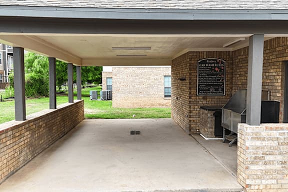 A covered walkway with a sign on the wall.