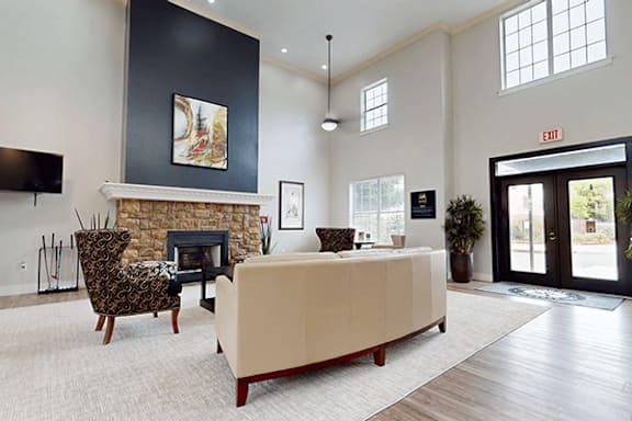 A living room with a fireplace and a chair.