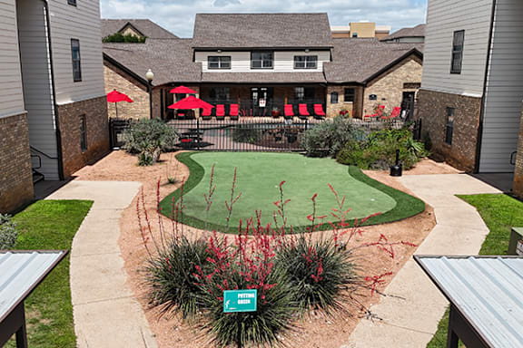 A green lawn with a sign that says "Bella Vista".