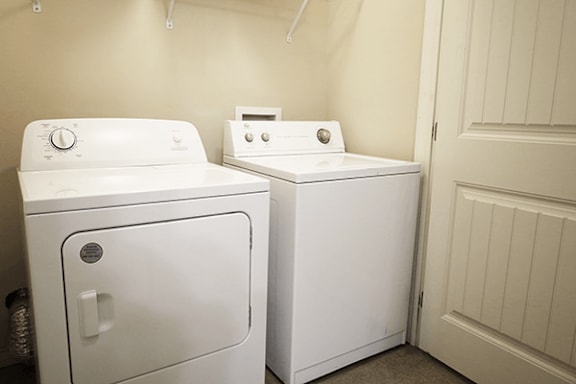 A white dryer and washer in a laundry room.