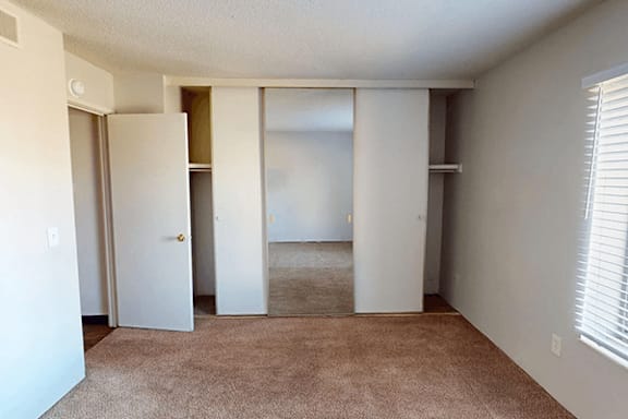 A room with a carpeted floor and white walls.