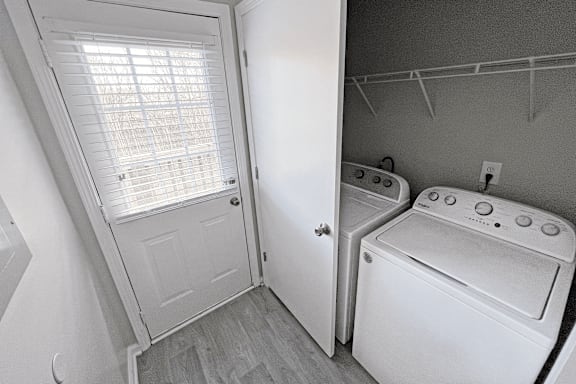A small laundry room with a washer and dryer.