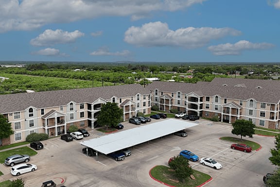 A large building with a parking lot in front of it.