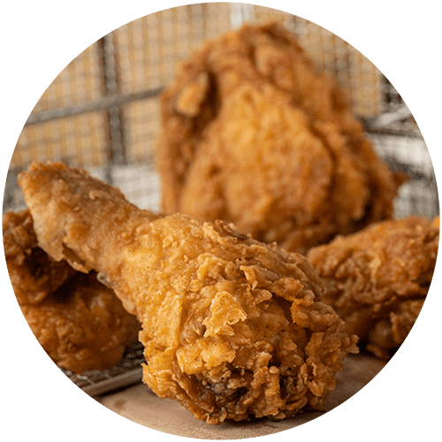 a row of fried chicken in a cage