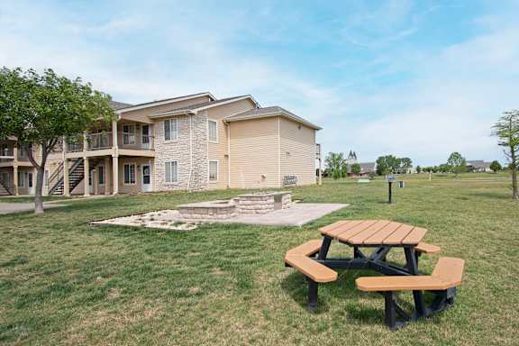 A picnic table sits in front of a building.