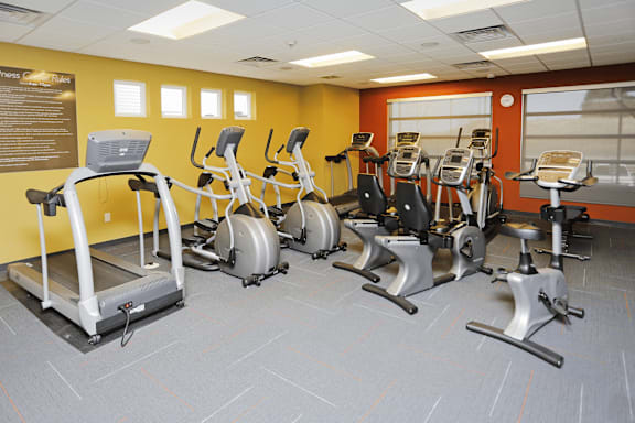 A gym with treadmills, exercise bikes, and elliptical machines.