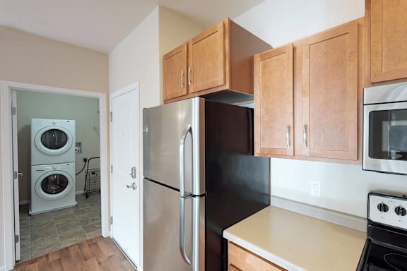 A kitchen with a black refrigerator, stove, and oven.