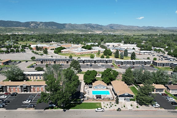A large building complex with a swimming pool in the middle.