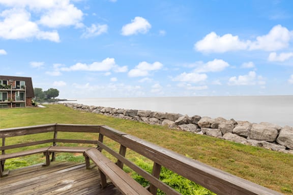 a view of the water from a deck with benches