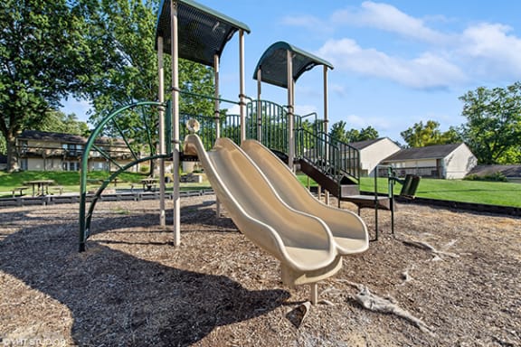 a playground with a slide and a climbing frame
