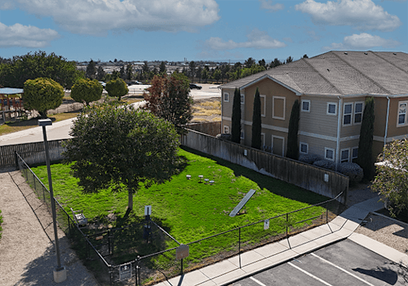 A residential area with houses and a green lawn.