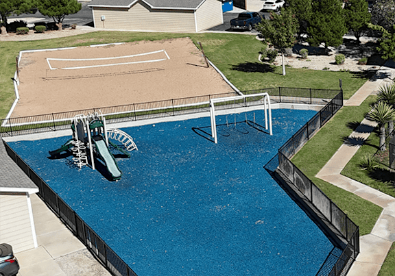 A small pool with a slide and a sandbox.
