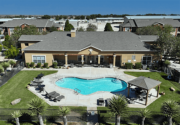A large house with a pool in the backyard.