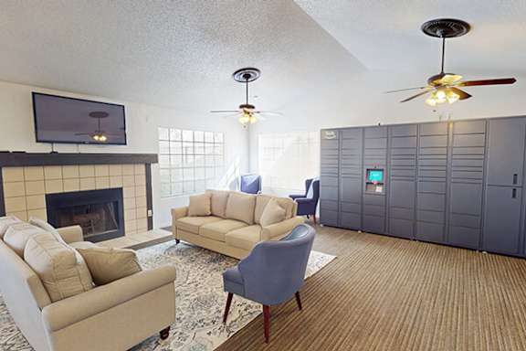 A living room with a fireplace, two couches, and a television.