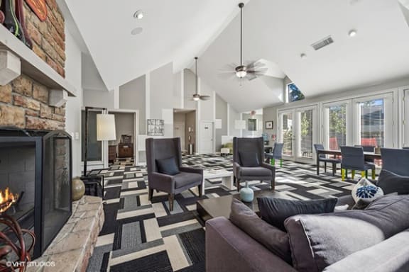 a living room with couches and chairs and a fireplace